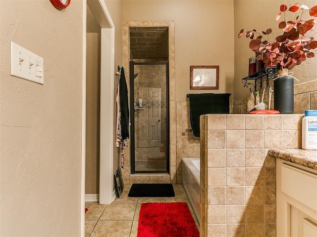 913 E Harrison Ave, Guthrie, OK 73044 - full bath featuring tile patterned floors, a bath, a stall shower, and vanity