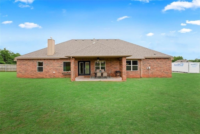 13640 Ridge View Ln, Edmond, OK 73025 - back of property featuring a chimney, a shingled roof, a patio area, and brick siding