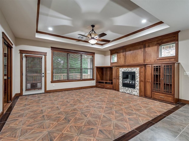 2120 Turtle Creek Dr, Norman, OK 73071 - living area featuring a raised ceiling, baseboards, a ceiling fan, a fireplace, and recessed lighting