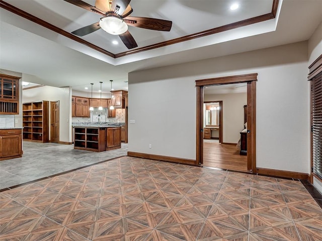 2120 Turtle Creek Dr, Norman, OK 73071 - unfurnished living room with baseboards, a tray ceiling, crown molding, a ceiling fan, and recessed lighting
