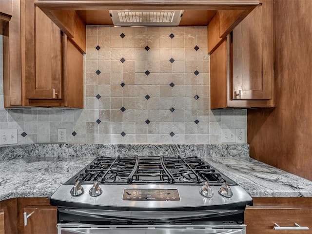 2120 Turtle Creek Dr, Norman, OK 73071 - kitchen with stainless steel range with gas cooktop, brown cabinets, backsplash, and light stone countertops