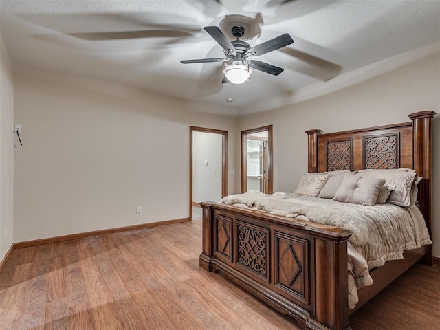2120 Turtle Creek Dr, Norman, OK 73071 - bedroom featuring baseboards, light wood finished floors, and a ceiling fan