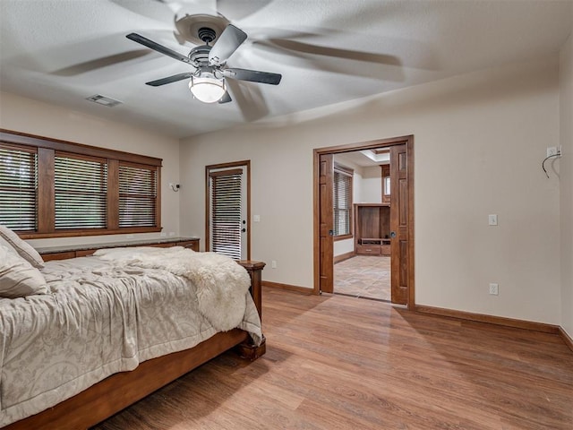 2120 Turtle Creek Dr, Norman, OK 73071 - bedroom with light wood-type flooring, baseboards, ceiling fan, and connected bathroom