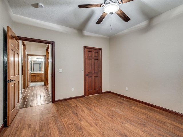 2120 Turtle Creek Dr, Norman, OK 73071 - unfurnished bedroom featuring light wood-type flooring, baseboards, and a ceiling fan
