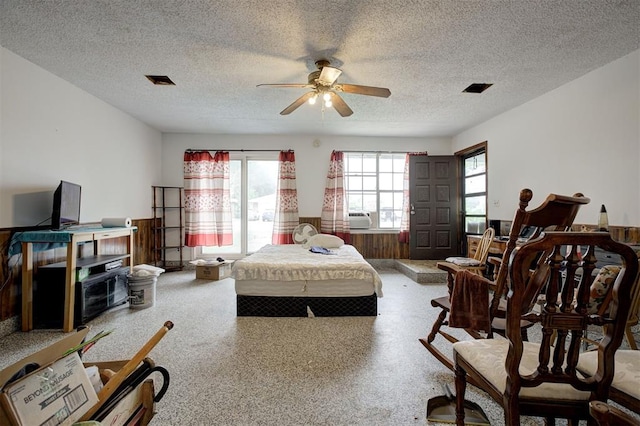 407 S Norman Ave, Moore, OK 73160 - bedroom with a textured ceiling, a ceiling fan, and cooling unit