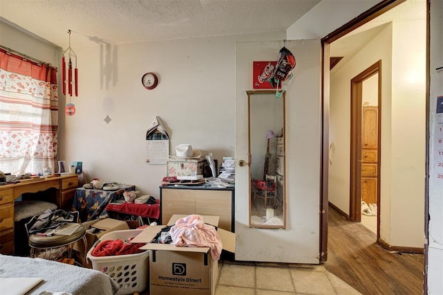 407 S Norman Ave, Moore, OK 73160 - bedroom with a textured ceiling and wood finished floors