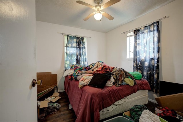 407 S Norman Ave, Moore, OK 73160 - bedroom featuring wood finished floors, ceiling fan, and a textured ceiling