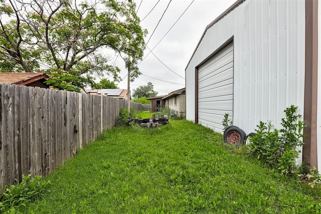 407 S Norman Ave, Moore, OK 73160 - fenced yard with a garage and a fire pit