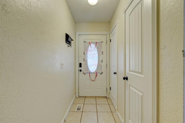 601 Oak Creek Dr, Yukon, OK 73099 - entryway with light tile patterned floors, a textured wall, and baseboards