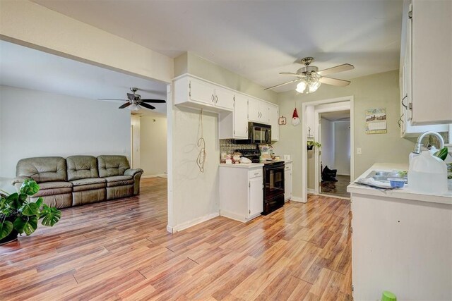 601 Oak Creek Dr, Yukon, OK 73099 - kitchen featuring black appliances, ceiling fan, light countertops, white cabinetry, and light wood-style floors