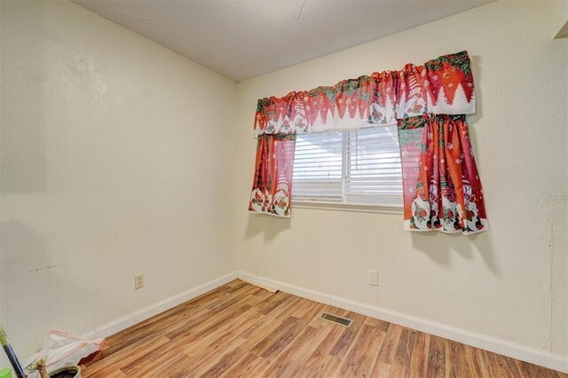 601 Oak Creek Dr, Yukon, OK 73099 - spare room featuring baseboards and light wood finished floors