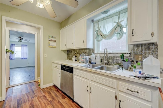 601 Oak Creek Dr, Yukon, OK 73099 - kitchen with stainless steel dishwasher, a sink, a ceiling fan, tasteful backsplash, and white cabinetry