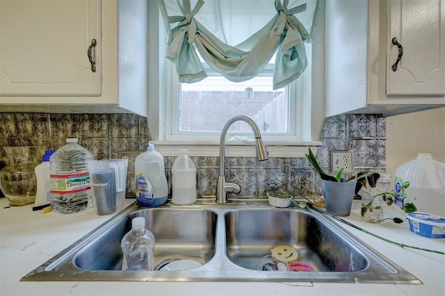 601 Oak Creek Dr, Yukon, OK 73099 - kitchen view of a sink, backsplash, white cabinets, and light countertops
