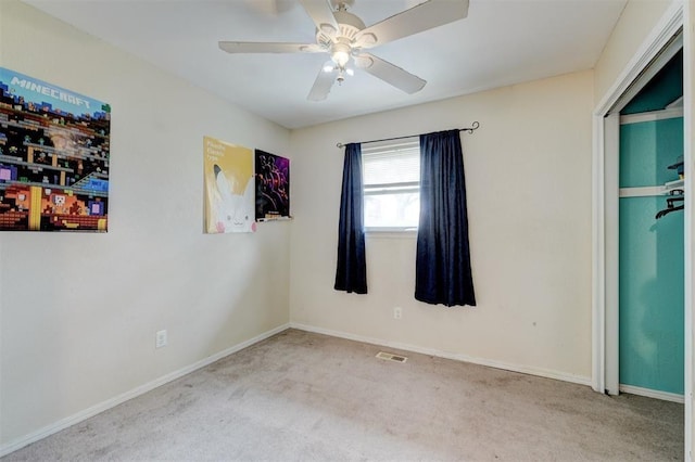 601 Oak Creek Dr, Yukon, OK 73099 - unfurnished bedroom with carpet floors, baseboards, and ceiling fan