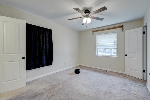 601 Oak Creek Dr, Yukon, OK 73099 - unfurnished bedroom with carpet, baseboards, and a ceiling fan