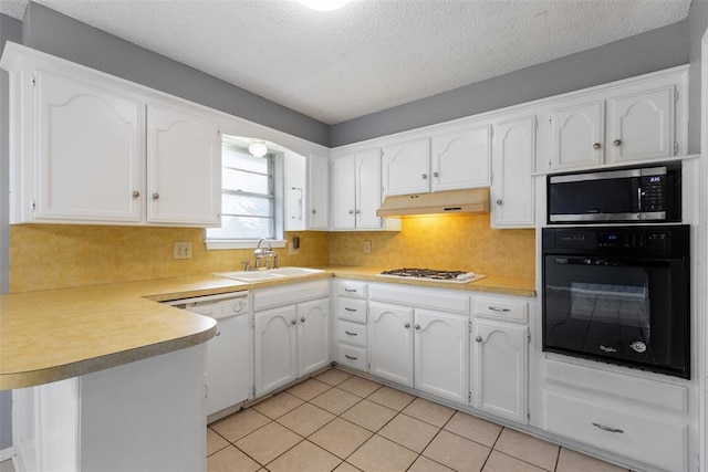 616 Willow Ridge Pl, Edmond, OK 73003 - kitchen with white appliances, a sink, a peninsula, under cabinet range hood, and white cabinets
