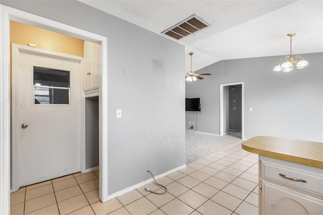 616 Willow Ridge Pl, Edmond, OK 73003 - kitchen featuring vaulted ceiling, light tile patterned floors, white cabinets, a ceiling fan, and baseboards