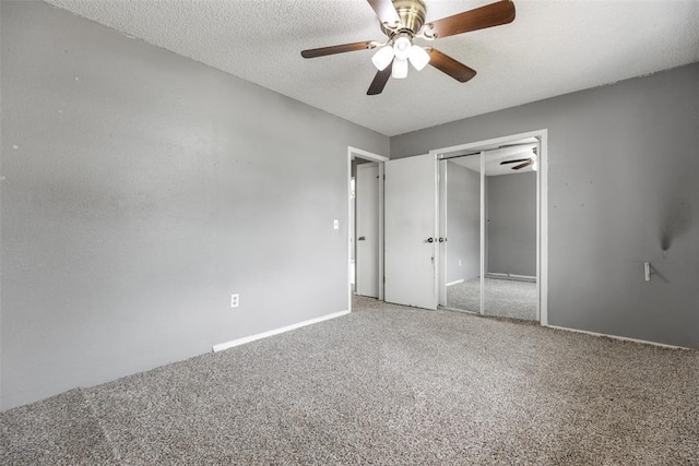 616 Willow Ridge Pl, Edmond, OK 73003 - unfurnished bedroom featuring carpet, a closet, baseboards, a textured ceiling, and a ceiling fan