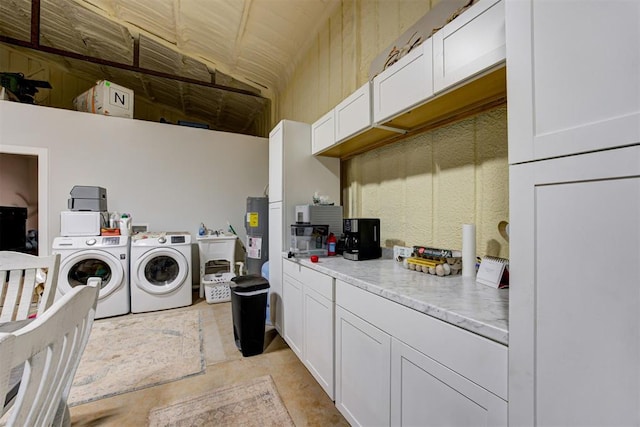 washroom featuring washer and clothes dryer and electric water heater