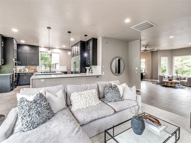 2113 Highlands Lndg, Edmond, OK 73013 - living room featuring recessed lighting, healthy amount of natural light, and a ceiling fan