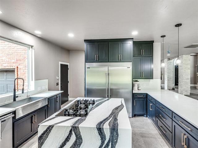 2113 Highlands Lndg, Edmond, OK 73013 - kitchen featuring appliances with stainless steel finishes, pendant lighting, recessed lighting, and a peninsula