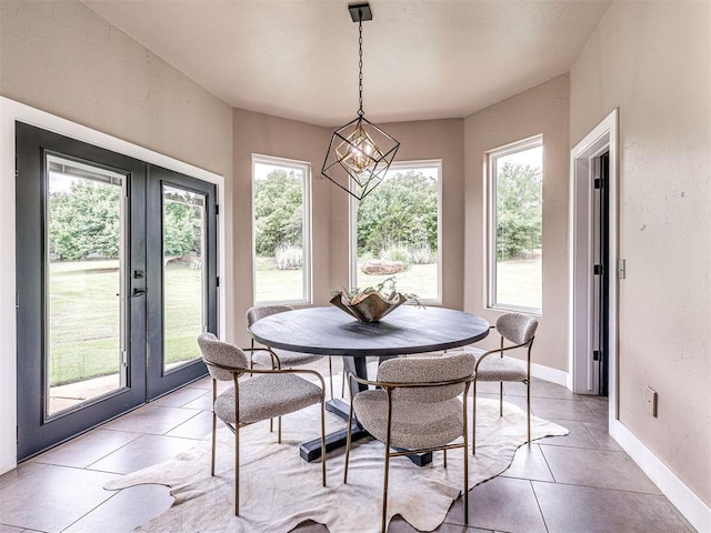 2113 Highlands Lndg, Edmond, OK 73013 - dining room with french doors, light tile patterned floors, and a chandelier