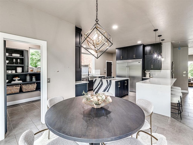 2113 Highlands Lndg, Edmond, OK 73013 - dining area featuring a chandelier and baseboards