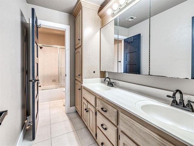 2113 Highlands Lndg, Edmond, OK 73013 - full bath with double vanity, bath / shower combo with glass door, and tile patterned floors