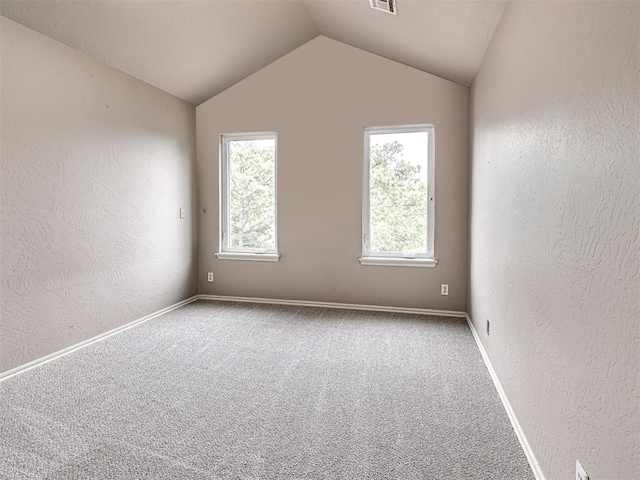 2113 Highlands Lndg, Edmond, OK 73013 - carpeted spare room with a textured wall, healthy amount of natural light, and lofted ceiling