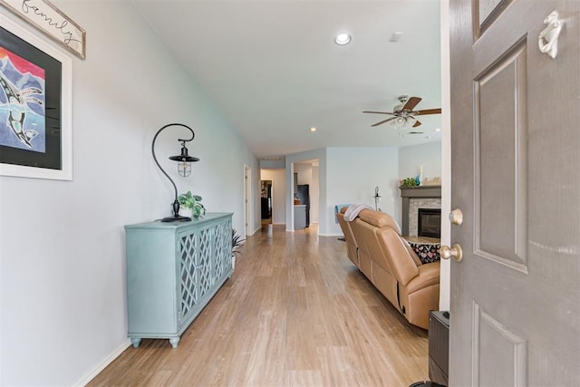 405 Bright Angel Trl, Edmond, OK 73003 - foyer featuring light wood-style flooring, a ceiling fan, baseboards, a glass covered fireplace, and recessed lighting