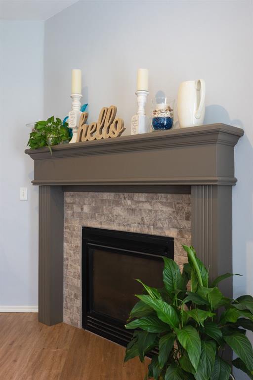 405 Bright Angel Trl, Edmond, OK 73003 - detailed view of wood finished floors, a fireplace, and baseboards