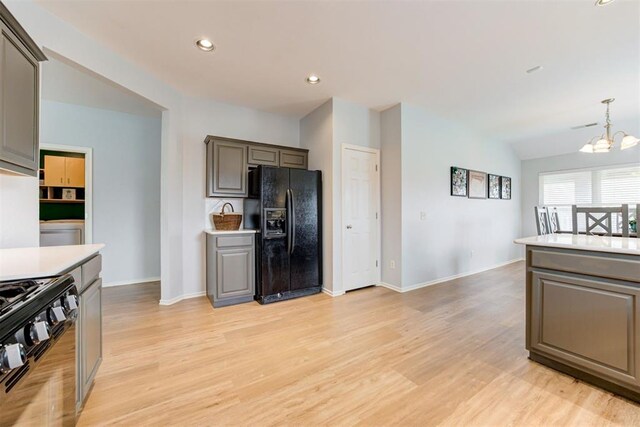 405 Bright Angel Trl, Edmond, OK 73003 - kitchen with black appliances, a chandelier, light wood-style floors, light countertops, and recessed lighting
