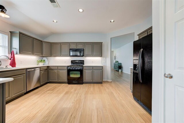 405 Bright Angel Trl, Edmond, OK 73003 - kitchen with black appliances, gray cabinetry, light wood-style floors, decorative backsplash, and light countertops