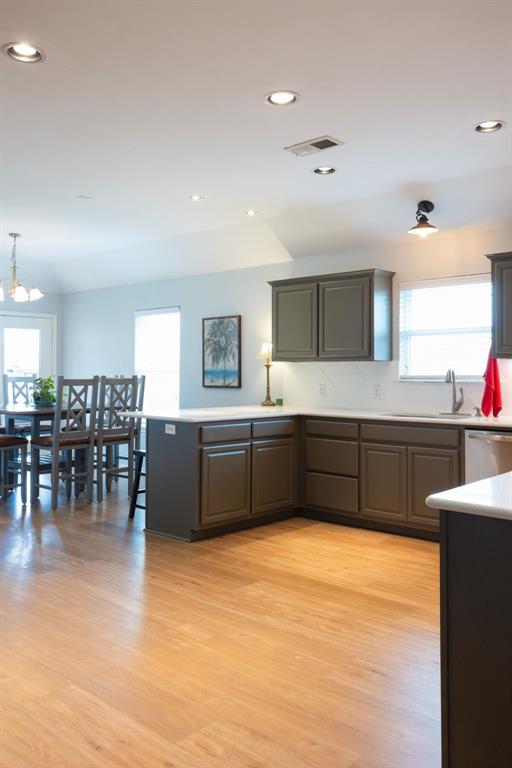 405 Bright Angel Trl, Edmond, OK 73003 - kitchen featuring healthy amount of natural light, light countertops, a sink, stainless steel dishwasher, and recessed lighting