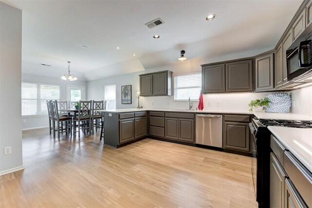 405 Bright Angel Trl, Edmond, OK 73003 - kitchen featuring black appliances, light wood-style floors, healthy amount of natural light, a chandelier, and recessed lighting