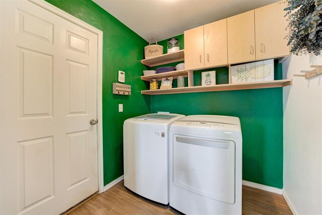 405 Bright Angel Trl, Edmond, OK 73003 - washroom featuring independent washer and dryer, cabinet space, wood finished floors, and baseboards
