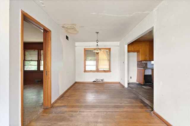 5321 S Douglas Ave, Oklahoma City, OK 73109 - unfurnished dining area featuring wood finished floors and baseboards