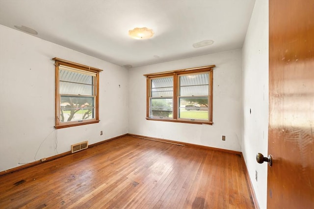 5321 S Douglas Ave, Oklahoma City, OK 73109 - empty room with healthy amount of natural light, hardwood / wood-style flooring, and baseboards