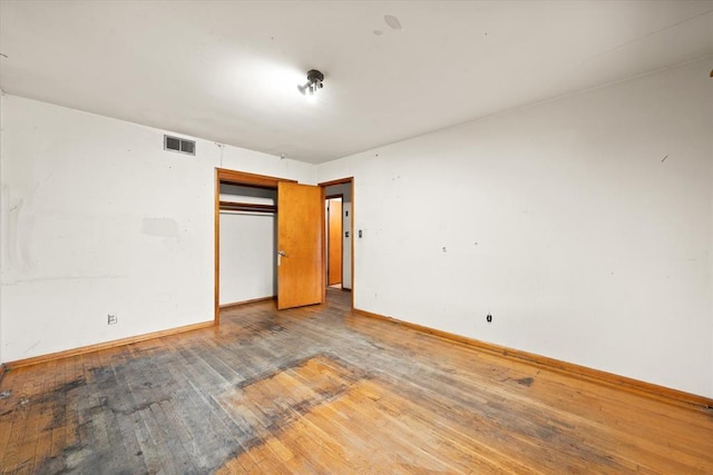 5321 S Douglas Ave, Oklahoma City, OK 73109 - unfurnished bedroom featuring hardwood / wood-style floors, baseboards, and a closet