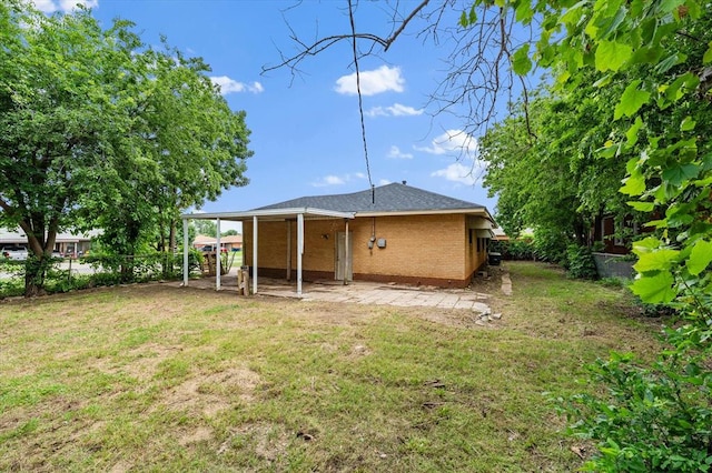 5321 S Douglas Ave, Oklahoma City, OK 73109 - back of property featuring brick siding and a patio area