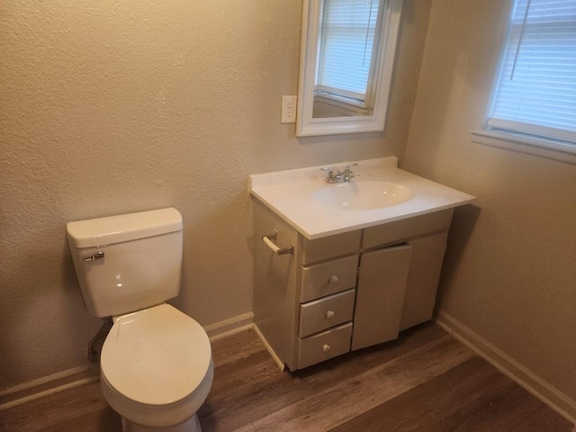 1003 E Whittaker St, Shawnee, OK 74801 - half bath featuring vanity, wood finished floors, baseboards, and toilet