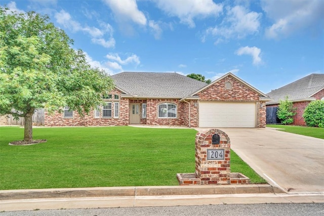 1204 Sheryl Ln, Altus, OK 73521 - view of front facade featuring an attached garage, driveway, a front yard, and a shingled roof
