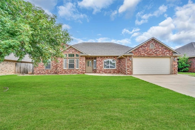 1204 Sheryl Ln, Altus, OK 73521 - view of front facade featuring a garage, concrete driveway, brick siding, and a shingled roof