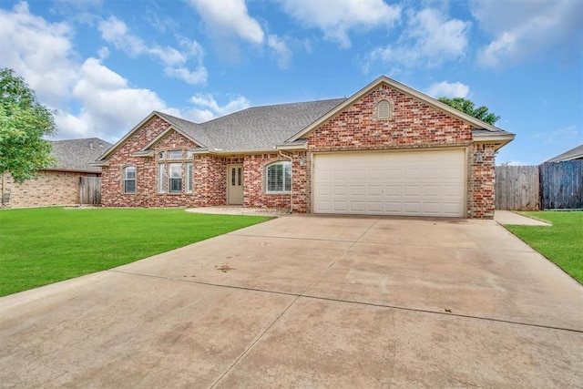 1204 Sheryl Ln, Altus, OK 73521 - view of front of home with driveway, brick siding, an attached garage, and a shingled roof