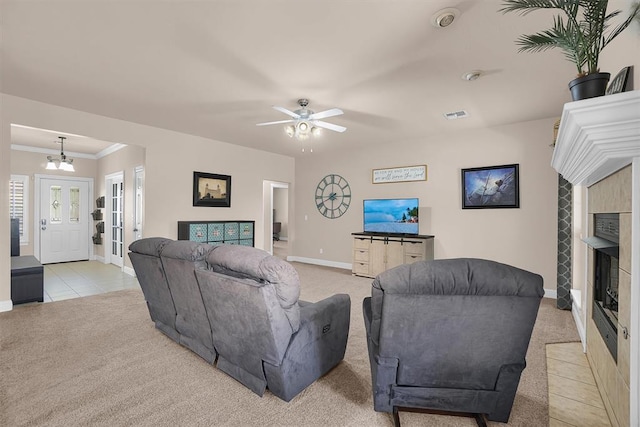 1204 Sheryl Ln, Altus, OK 73521 - living area featuring light carpet, baseboards, a tile fireplace, a ceiling fan, and crown molding