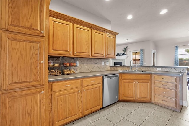 1204 Sheryl Ln, Altus, OK 73521 - kitchen with stainless steel dishwasher, a sink, recessed lighting, tasteful backsplash, and a peninsula