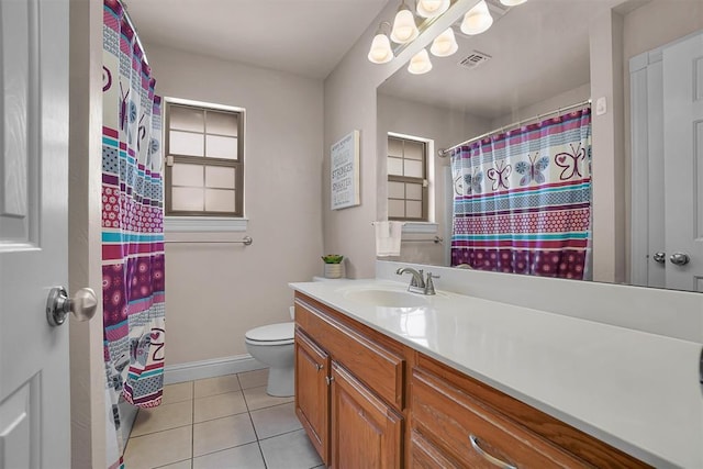 1204 Sheryl Ln, Altus, OK 73521 - bathroom with vanity, tile patterned flooring, toilet, baseboards, and healthy amount of natural light