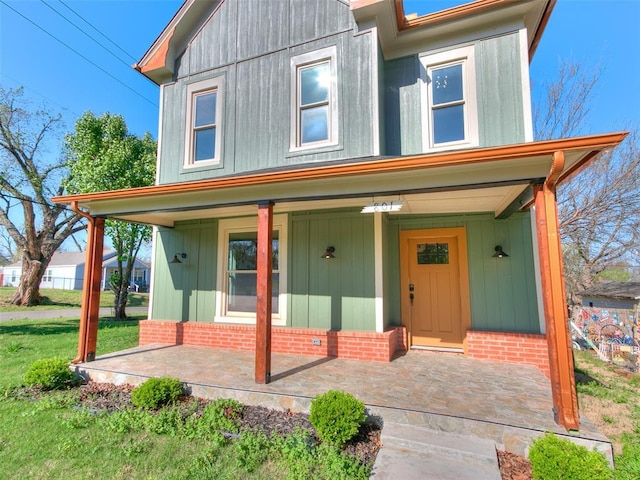 801 N Ash St, Guthrie, OK 73044 - view of front of property with covered porch and brick siding