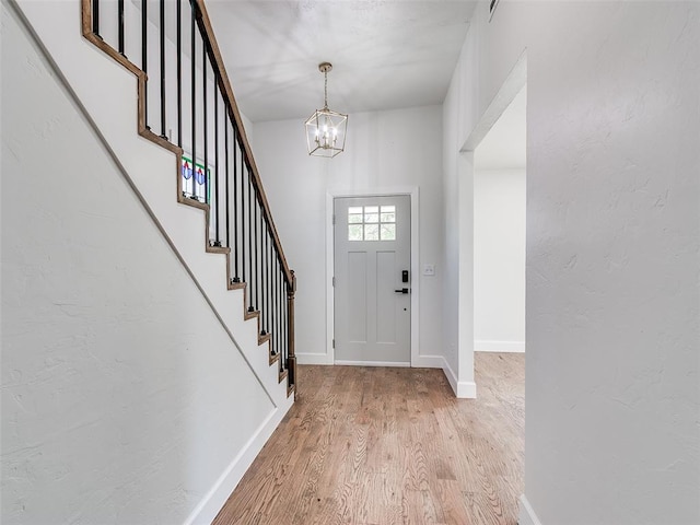 801 N Ash St, Guthrie, OK 73044 - entrance foyer with light wood-type flooring, a chandelier, stairs, and baseboards