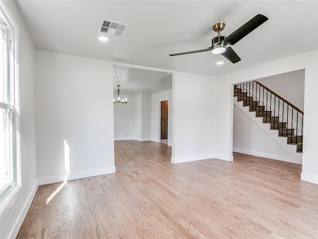 801 N Ash St, Guthrie, OK 73044 - spare room featuring a chandelier, light wood-type flooring, stairway, ceiling fan, and baseboards